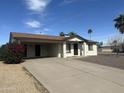 Charming single-story home with a spacious driveway and well-maintained landscaping under a clear blue sky at 5255 S Mill Ave, Tempe, AZ 85283
