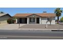 Inviting single-story home with a well-maintained front yard, neutral tones, and an attached carport at 5255 S Mill Ave, Tempe, AZ 85283