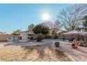 Inviting backyard oasis with a sparkling pool, fire pit, and patio at 553 E Kyle Ct, Gilbert, AZ 85296