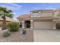 Two-story house with tan exterior, tile roof, and landscaped front yard at 5951 E Trailridge St, Mesa, AZ 85215