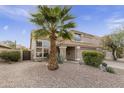 Tan two-story house with a palm tree and gravel landscaping at 5951 E Trailridge St, Mesa, AZ 85215