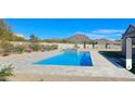 Inviting backyard with a sparkling blue pool and spa, set against a serene mountain backdrop at 8714 E Tether Trl, Scottsdale, AZ 85255