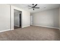 Spacious bedroom with ceiling fan and carpeted floors at 21165 W Carver Rd, Buckeye, AZ 85326