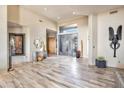 Spacious entry with tile floors, modern light fixtures and statement art at 10040 E Happy Valley Rd # 2001, Scottsdale, AZ 85255