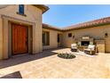 An inviting outdoor courtyard featuring a fireplace and seating area at 14539 W Sheridan St, Goodyear, AZ 85395