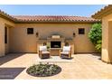 An inviting outdoor courtyard featuring a fireplace and seating area at 14539 W Sheridan St, Goodyear, AZ 85395