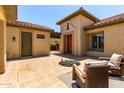Inviting outdoor courtyard with fireplace, tiled patio, and comfortable seating at 14539 W Sheridan St, Goodyear, AZ 85395