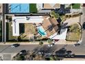 Aerial view of house, pool, and backyard, tennis court visible at 4461 E Flower St, Phoenix, AZ 85018