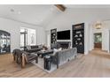 Bright living room featuring a fireplace, built-in shelving, and hardwood floors, offering a cozy and elegant living space at 6040 E Lafayette Blvd, Scottsdale, AZ 85251