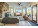 Spacious living room with stone fireplace and large windows at 6074 E Los Reales Dr, Carefree, AZ 85377