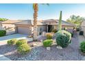 Single-story home with desert landscaping and a two-car garage at 19425 N Guardian Ln, Surprise, AZ 85387
