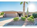 Single-story home with desert landscaping, two-car garage, and inviting entrance at 19425 N Guardian Ln, Surprise, AZ 85387