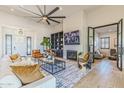 Spacious living room with modern fireplace, built-in shelving, and a large sectional sofa near black-trimmed doors at 19702 E Melissa Pl, Queen Creek, AZ 85142