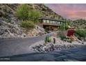 Modern home with long driveway leading to attached garage, desert landscaping at 5800 E Glen Dr, Paradise Valley, AZ 85253