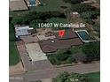 Aerial view of a charming home featuring a private pool, mature trees, and ample parking at 10407 W Catalina Dr, Avondale, AZ 85392