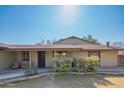 Ranch style home with carport and mature landscaping at 10407 W Catalina Dr, Avondale, AZ 85392