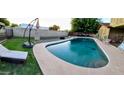 Inviting backyard pool perfect for cooling off on a hot day with poolside lounging and a lush green lawn at 10407 W Catalina Dr, Avondale, AZ 85392