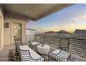 Spacious balcony featuring comfortable seating and picturesque mountain views with a beautiful sunset at 14828 E Valley Vista Dr, Fountain Hills, AZ 85268