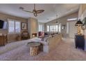 Comfortable living room with a stone fireplace and large windows at 3212 E Desert Cove Ave, Phoenix, AZ 85028