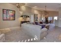Bright living room featuring a large sectional sofa and neutral color palette at 3212 E Desert Cove Ave, Phoenix, AZ 85028