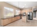 Kitchen with light wood cabinets, stainless steel appliances, and an island at 8141 E Apache Plumb Dr, Gold Canyon, AZ 85118
