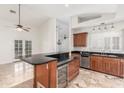 Bright kitchen with granite countertops, marble flooring, stainless steel dishwasher, and wine cooler at 905 E Knight Ln, Tempe, AZ 85284
