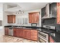 Modern kitchen with stainless steel appliances, sleek range hood, and ample countertop space at 905 E Knight Ln, Tempe, AZ 85284