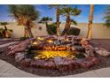 Backyard water feature with illuminated waterfall and pond at 13520 W Junipero Dr, Sun City West, AZ 85375