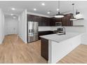 Modern kitchen featuring stainless steel appliances, dark cabinets, a large island and white subway tile backsplash at 7641 W Minton St, Laveen, AZ 85339