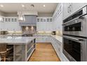 Modern kitchen features stainless steel appliances, white cabinets, a center island, and hardwood flooring at 11885 N Sunset Vista Dr, Fountain Hills, AZ 85268