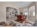 Bright dining room with a glass-top table and wooden chairs at 1435 E Debbie Dr, San Tan Valley, AZ 85140