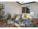 Charming water feature with stone accents, surrounded by a garden with colorful flowers and lush greenery at 1440 E Secretariat Dr, Tempe, AZ 85284