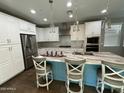 Modern kitchen with stainless steel appliances, white cabinets, granite countertops, and a center island at 1669 S Wallrade Ln, Gilbert, AZ 85295