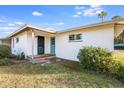Side view of the house, showcasing a teal door and landscaping at 1905 W Cambridge Ave, Phoenix, AZ 85009