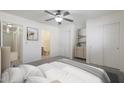 Well-lit bedroom with neutral tones, closet, ensuite bath, and ceiling fan at 22814 W Cantilever St, Buckeye, AZ 85326