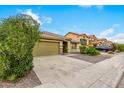 House exterior with a green garage door and desert landscaping at 2440 W Bloch Rd, Phoenix, AZ 85041