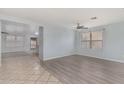 Spacious living room featuring wood-look floors and soft blue walls at 2440 W Bloch Rd, Phoenix, AZ 85041