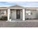 House entrance with a black metal door and white columns at 10436 N Balboa Dr, Sun City, AZ 85351