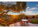 Small patio with seating for two and scenic sunset views at 11157 E Greenway Rd, Scottsdale, AZ 85255