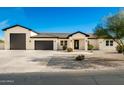 New construction home with a modern design, featuring a large driveway and two-car garage at 2917 N Katie Ln, Litchfield Park, AZ 85340