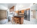 Kitchen boasts granite countertops and breakfast bar with two stools at 3433 W Mescal St, Phoenix, AZ 85029