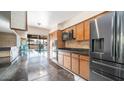 Kitchen features granite countertops, stainless steel appliances, and backyard views at 3433 W Mescal St, Phoenix, AZ 85029