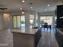 Open concept kitchen has a large island, granite countertops, modern appliances, and ample cabinet space at 4866 N 185Th Dr, Goodyear, AZ 85395