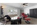 Bright living room featuring a comfy recliner and large window at 5835 E Dodge St, Mesa, AZ 85205