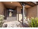 Front entry with iron gate, tile flooring, and desert landscaping at 9814 W Rowel Rd, Peoria, AZ 85383