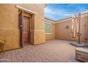 Private courtyard with brick pavers and an outdoor umbrella at 4219 N 161St Ave, Goodyear, AZ 85395