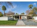 Mid-century modern home with landscaped yard and attached carport at 5708 N 11Th St, Phoenix, AZ 85014