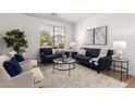 Cozy living room with plush seating, stylish decor, and a large window providing natural light at 135 E Julian Dr, Gilbert, AZ 85295