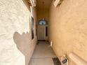 A covered walkway leads to the front door, providing shade and a sense of privacy as you approach the home at 18068 W Browning Dr, Surprise, AZ 85374