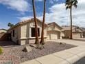 Charming single-story home with a terra cotta tile roof and low maintenance desert landscaping at 18068 W Browning Dr, Surprise, AZ 85374
